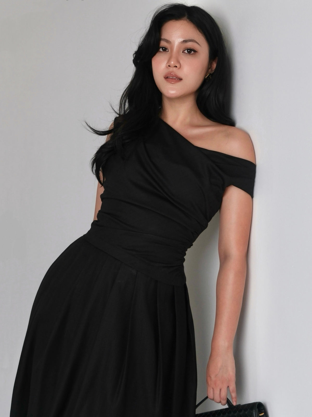 A mood in black.Powerful, feminine, and effortlessly refined. A silhouette designed to flatter, with soft draping and...