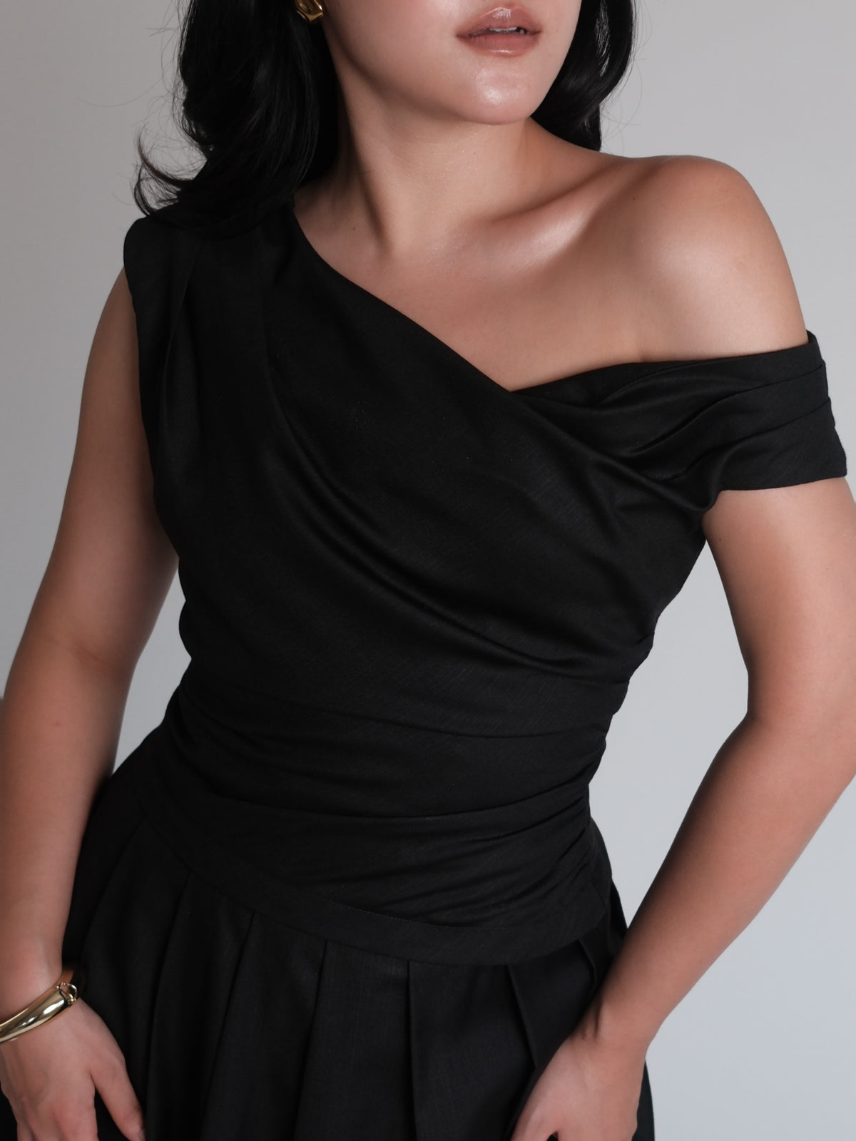 A mood in black.Powerful, feminine, and effortlessly refined. A silhouette designed to flatter, with soft draping and...